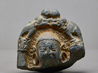 Lot 9 - STONE HEAD OF A BUDDHA WITH ATTENDANT ELEPHANTS, KASHMIR REGION, 4TH–5TH CENTURY